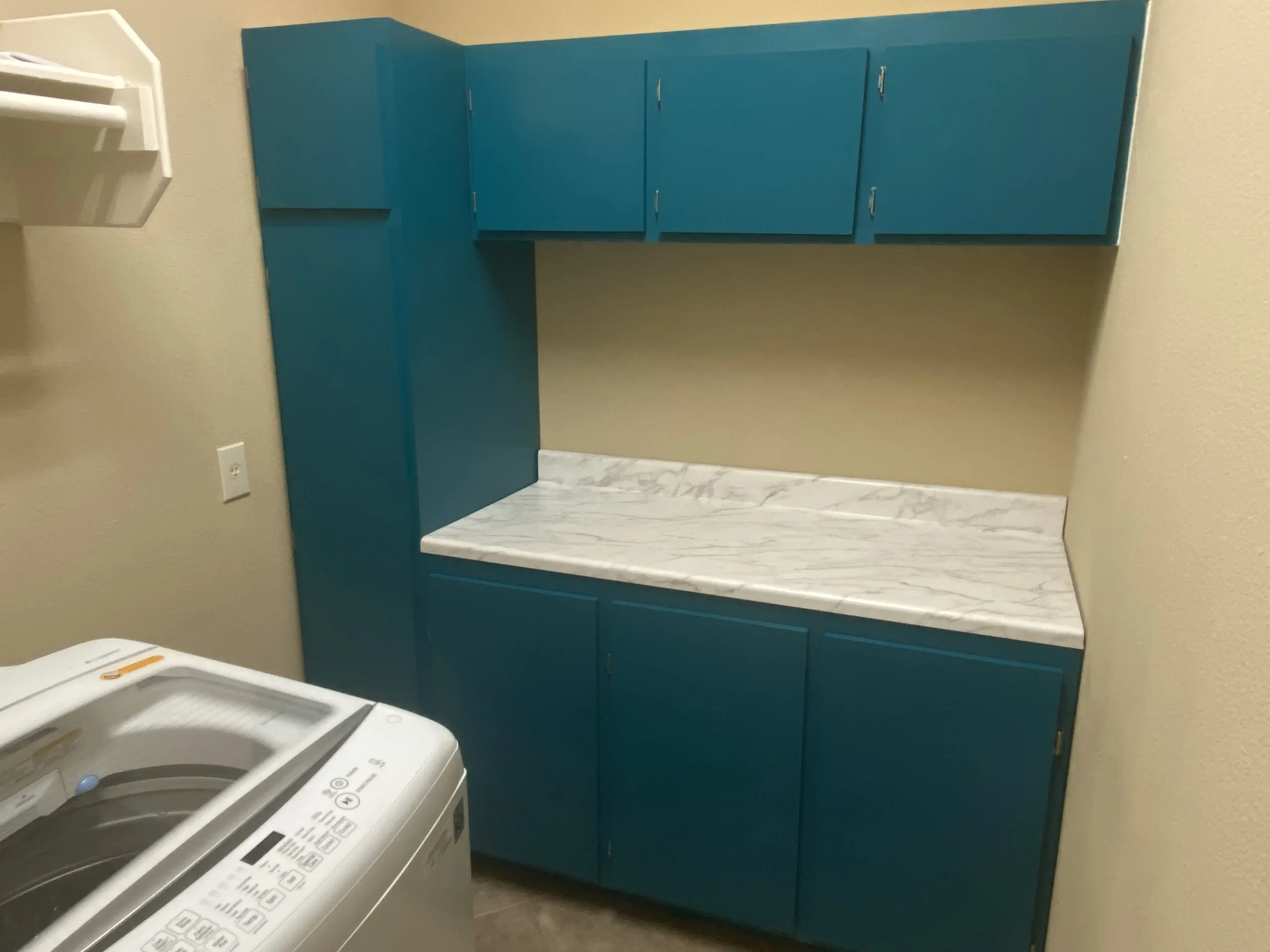 Custom laundry room cabinets and storage in Oak Run community